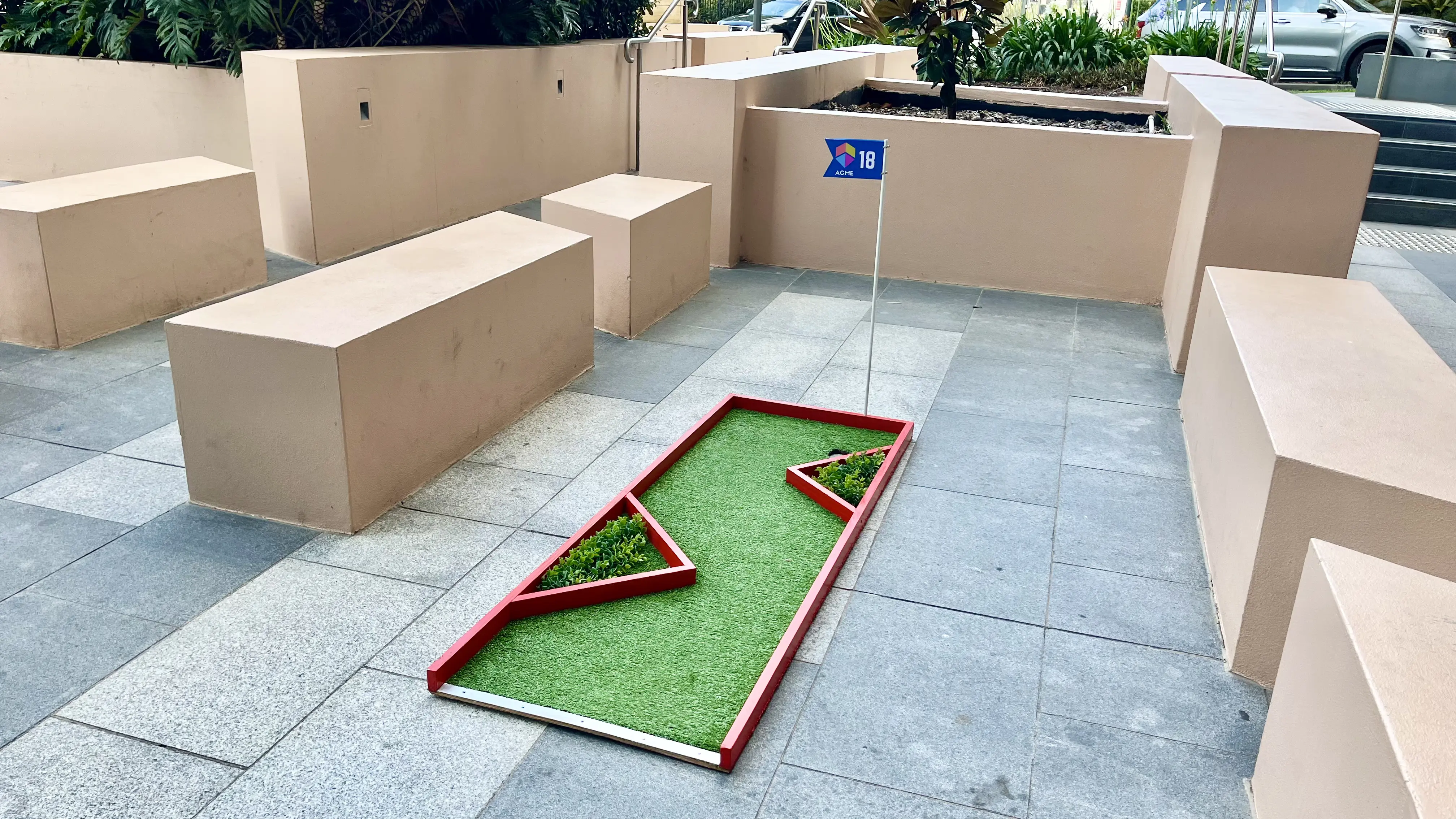 Hole-in-one promotional corporate mini golf hire with custom flag